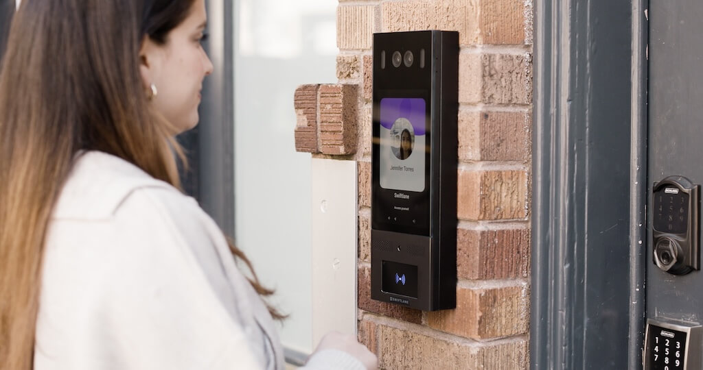 Woman using a video intercom to enter the building