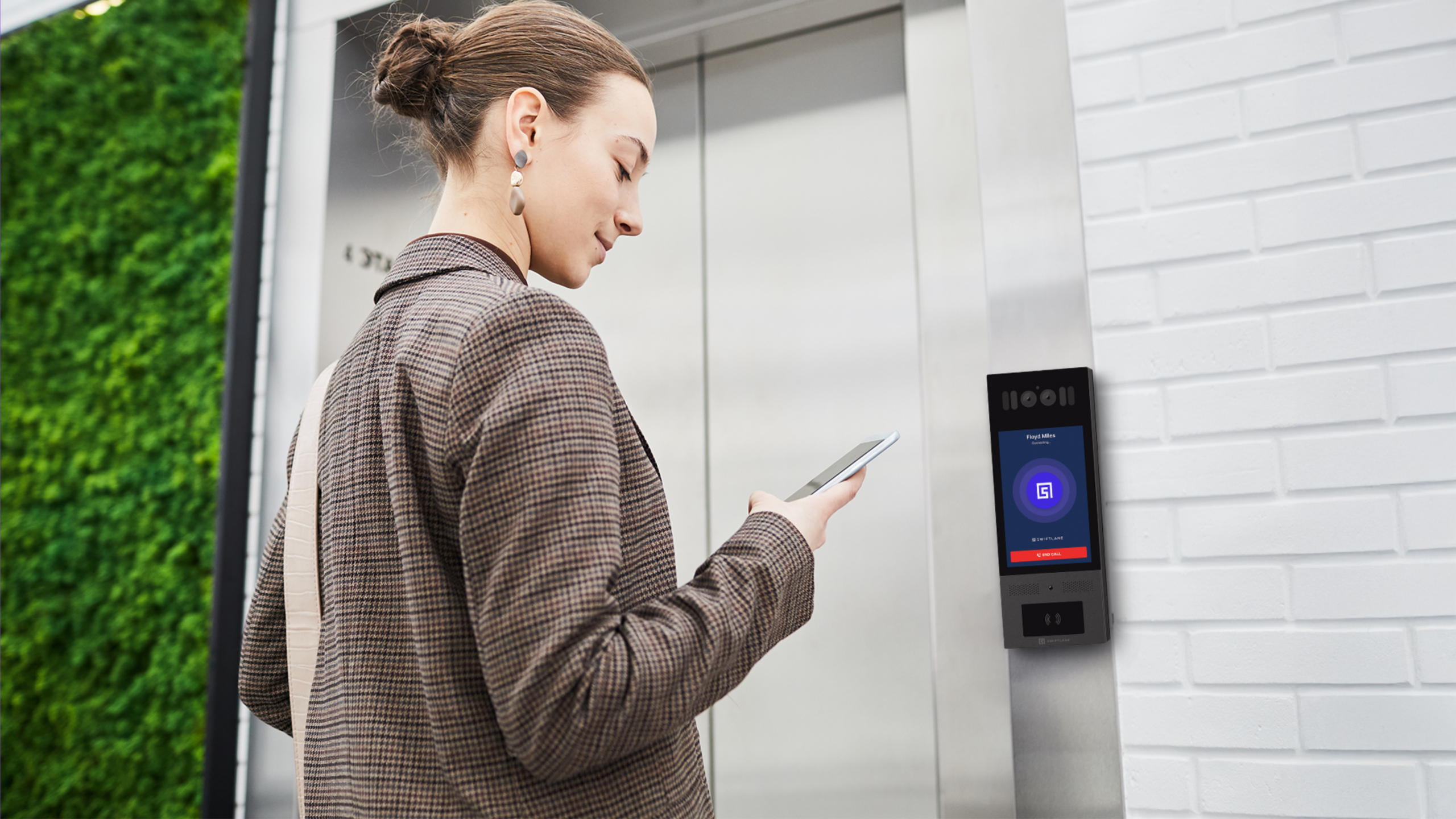 person operating intercom for elevator access control