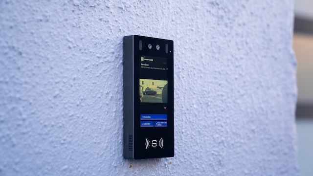 Swiftlane intercom mounted on a brick wall