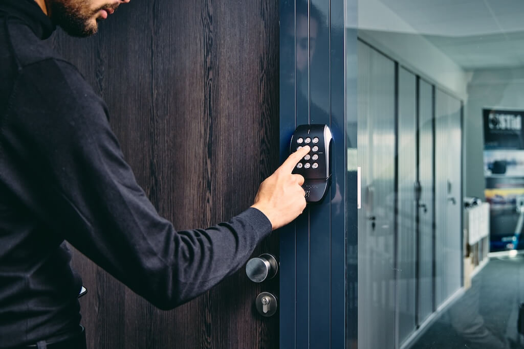 Man clicking the keypad to enter the room