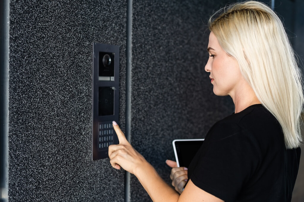 woman using video intercom in a building