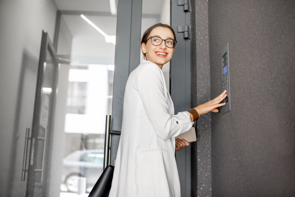 business woman pressing the buttons of the intercom system