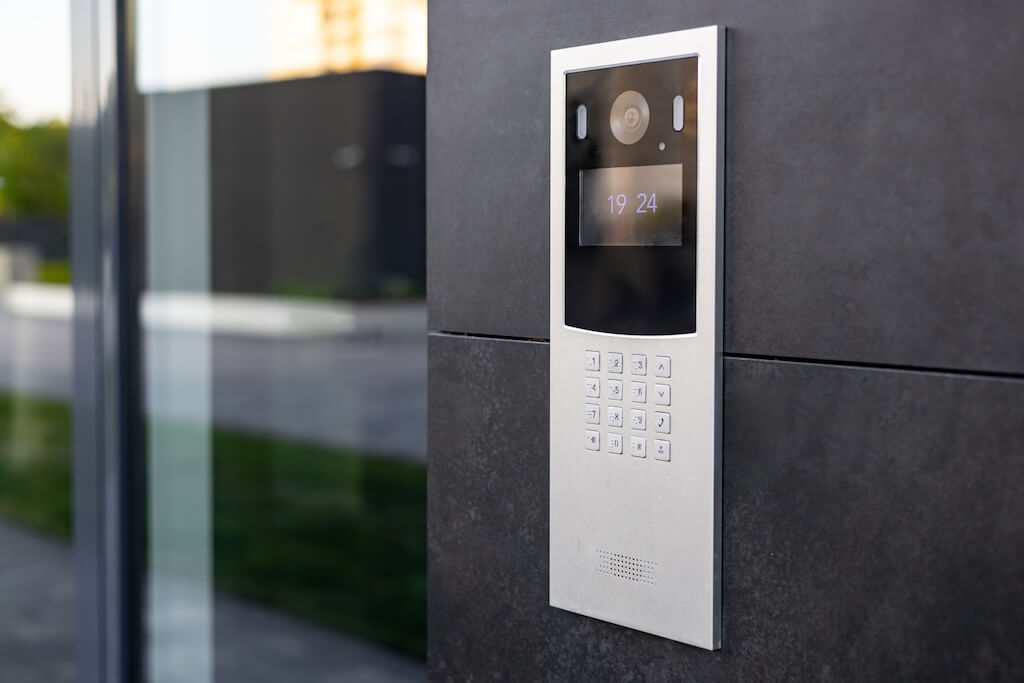 Intercom in a multi-apartment building entrance, with a video surveillance camera