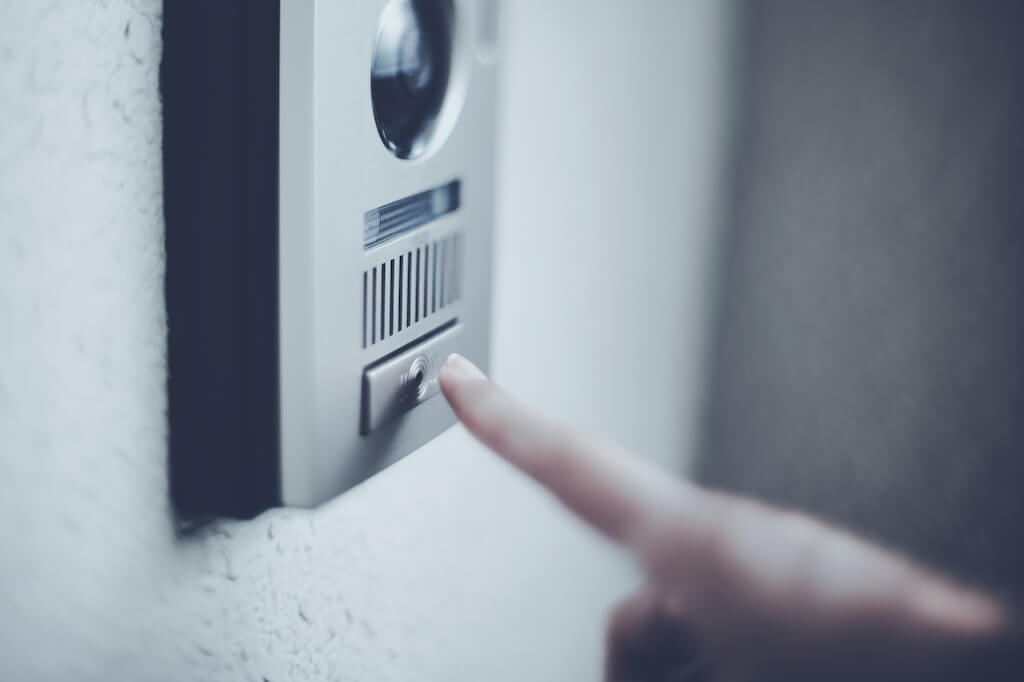 person pressing the intercom