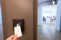 person using key card with an RFID reader