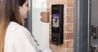 Woman using a video intercom to enter the building