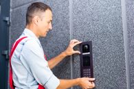 professional installing intercom at building entrance