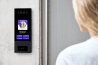 Woman using Swiftlane intercom to enter the building