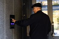 elderly person using swiftlane video intercom at building entry