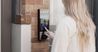Woman using a building intercom