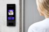 a woman using a video intercom system