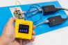 Man measuring the PoE power voltage using data cable tester