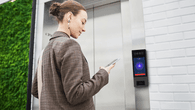 person operating intercom for elevator access control