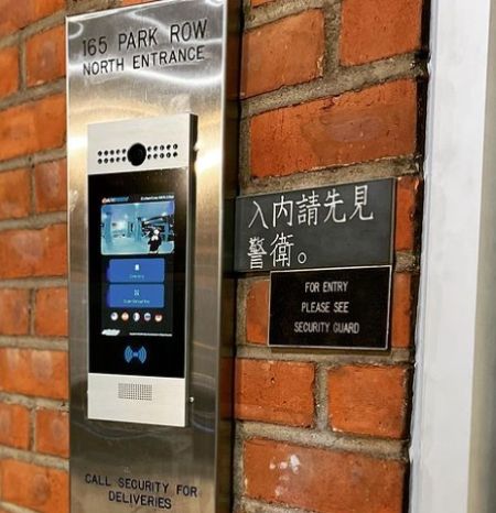 AlphaTouch intercom mounted on a wall outside a building