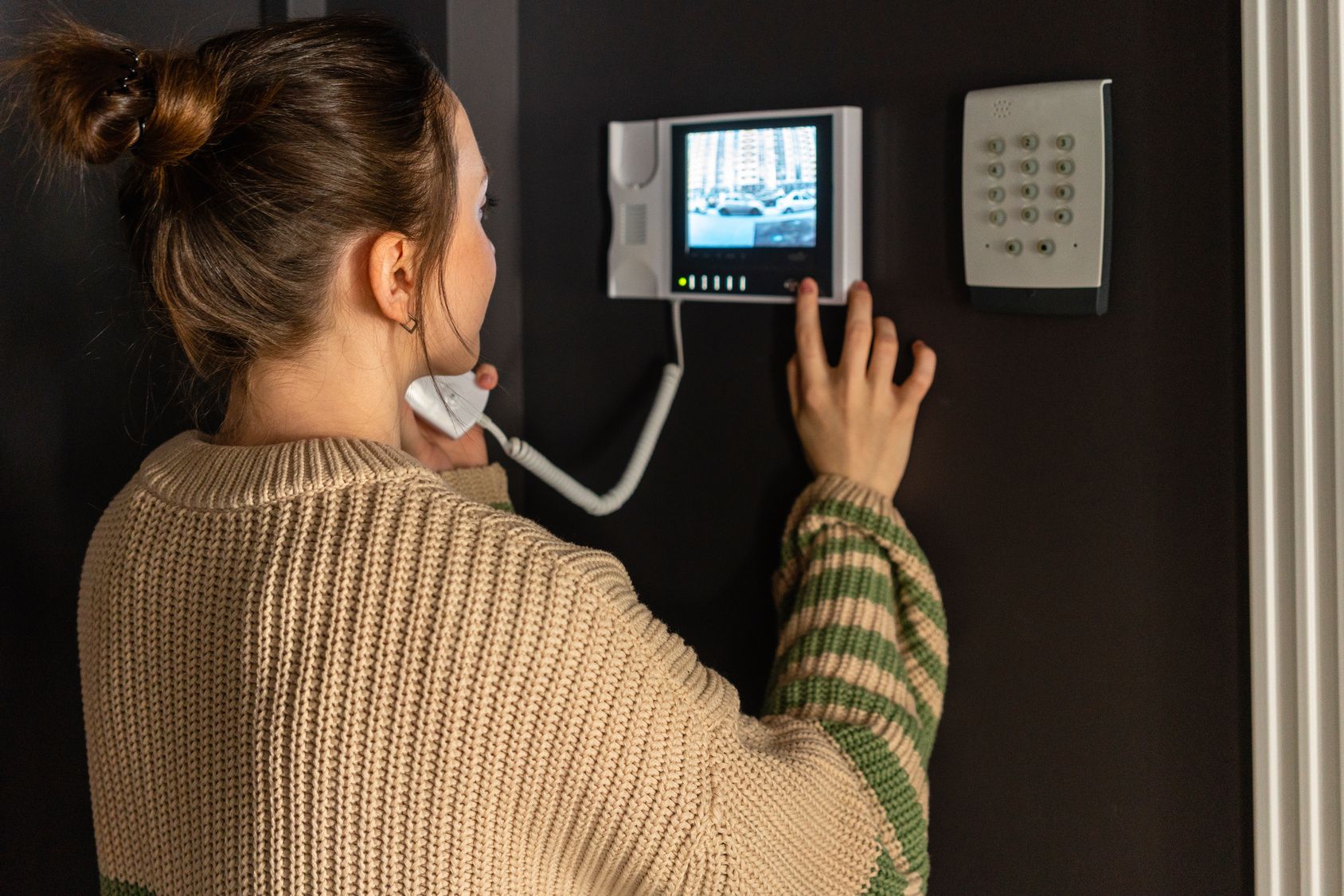 A woman using a video intercom